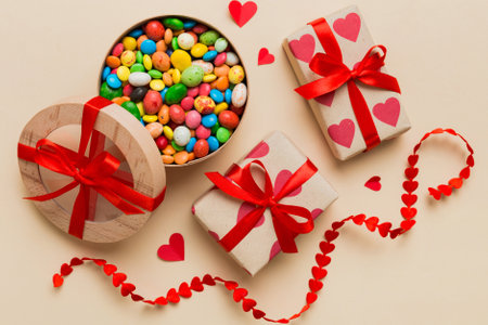 Valentine day composition: sweet candy, with gift boxes with and red felt hearts, photo bow template, background. Top View with copy space.の写真素材