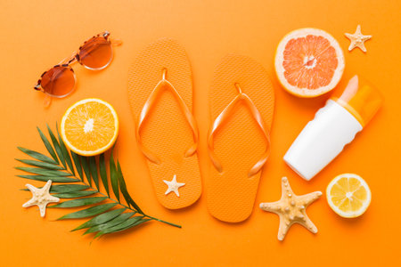 Top view composition of flip flops placed with beach accessories top view on table background. Tropical summer vacation concept Flat lay.の写真素材
