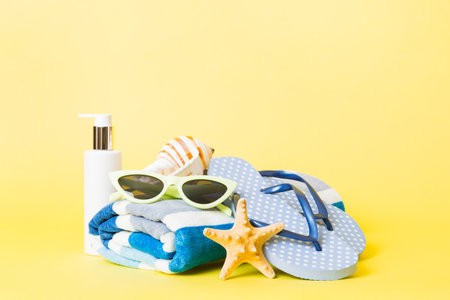 Top view composition of flip flops placed with beach accessories perspective view on table...