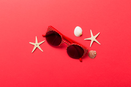 sunglasses with seashell lying on table background. Sunglasses on summer background. Top view flat lay with copy space for text.の写真素材