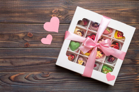 Valentine day composition: sweet candy, with gift boxes with and red felt hearts, photo bow template, background. Top View with copy space.の写真素材