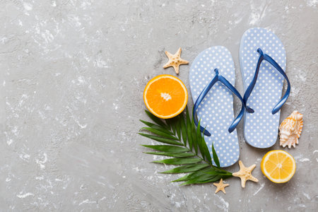 Top view composition of flip flops placed with beach accessories top view on table background. Tropical summer vacation concept Flat lay.の写真素材