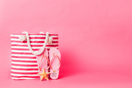 Stylish bag with beach accessories. Summer holiday concept. beach bag with straw hat with space for...