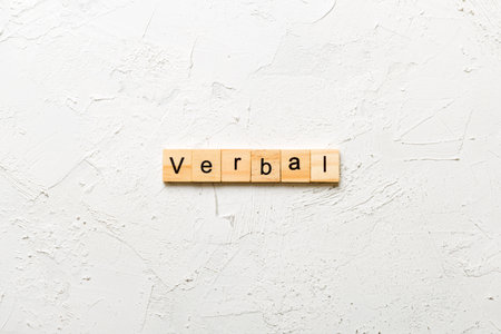 verbal written word on wood block. verbal text on table, concept.の写真素材