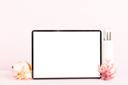 Flat lay composition with tablet and beach accessories on colored background. Tablet computer with blank screen mock up with copy space.の写真素材