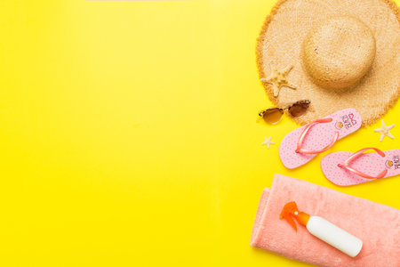 Top view travel or vacation concept. Composition with stylish beach accessories on colored...