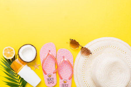 Top view of various seashells placed near colorful fruit and stylish summer accessories on table...