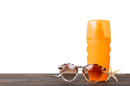 Professional Summer face skincare. Unbranded bottle with moisturizing liquid. Cream or lotion. Summer decorations, seashell and starfish, on table with isolated background. Beauty concept Perspective view with copy space for text.の写真素材
