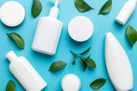 Organic cosmetic products with green leaves on color background. flat lay.の写真素材