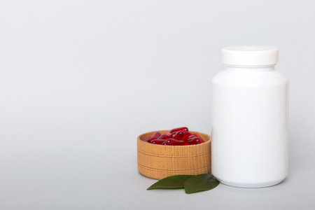 different drugs and health supplement pills with medicine bottle health care and medical top view. Vitamin tablets. Bottle with colored pills on table background. Multivitamins.の写真素材