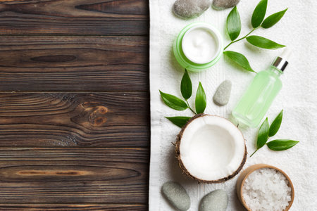 Coconut with jars of coconut oil and cosmetic cream on colored background. Top view. Free space for your text. Natural spa coconut cosmetics and organic treatment concept Coconut Spa composition.の写真素材