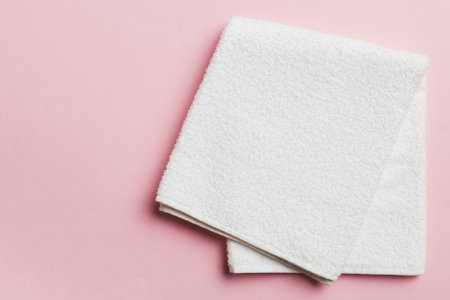 Top view of white towels with copy space on colored background.の写真素材