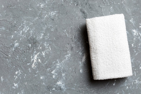 Top view of white towels with copy space on colored background.の写真素材