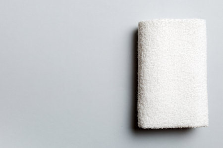 Top view of white towels with copy space on colored background.の写真素材