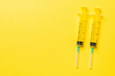 Top view of different injection syringes on colorful background. Medical equipment concept with copy space.の写真素材