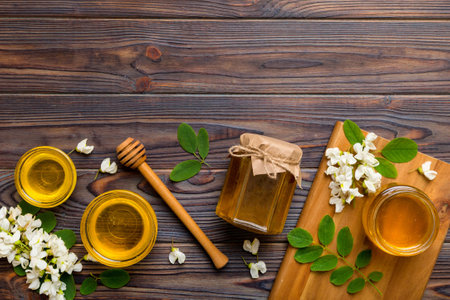 honey jar with acacia flowers and leaves. fresh honey top view flat lay.の写真素材