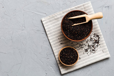 quinoa seeds in bowl and spoon on colored background. Healthy kinwa in small bowl. Healthy superfood.の写真素材