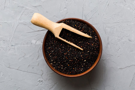 quinoa seeds in bowl and spoon on colored background. Healthy kinwa in small bowl. Healthy superfood.の写真素材