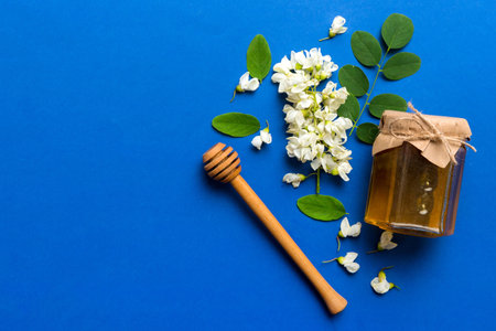 honey jar with acacia flowers and leaves. fresh honey top view flat lay.の写真素材