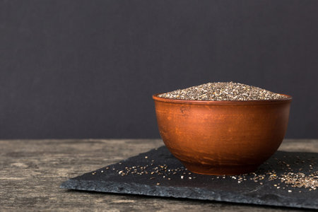 Chia seeds in bowl on colored background. Healthy Salvia hispanica in small bowl. Healthy superfood.の写真素材