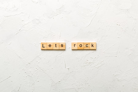 Let's Rock word written on wood block. Lets Rock text on cement table for your design, concept.