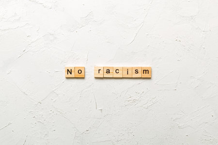 No racism word written on wood block. No racism text on table, concept.の写真素材