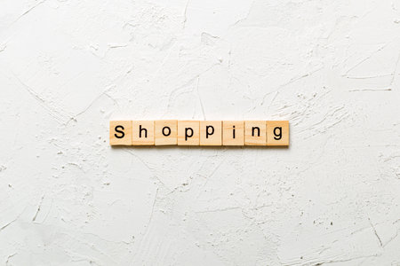 shopping written word on wood block. shopping text on cement table for your design, concept.の写真素材