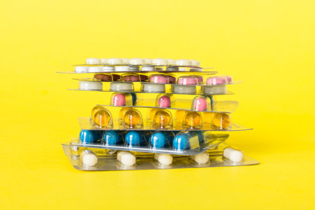 too many different pill cartridges stacked. selective focus. Packs of blister pills with tablets. Colored pastilles packages. A pile of medicine in blister packs. Pharmaceutical blister packs.の写真素材