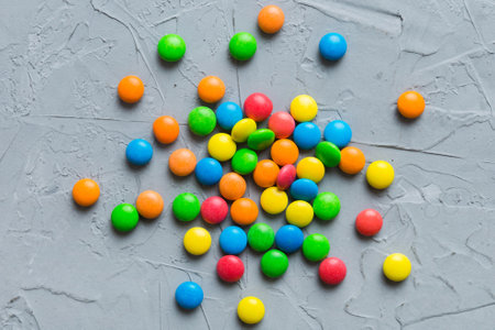 Mixed collection of colorful candy, on colored background. Flat lay, top view.の写真素材