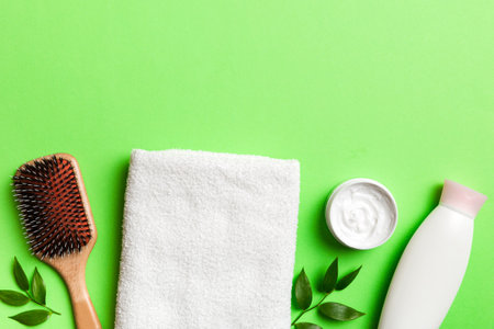 cosmetic for hair care, cream and towel on a colored background top view. flat lay.の写真素材