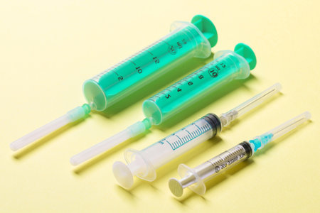 Top view of syringes in a row for medical injection on colorful background with copy space. Health and vaccination concept.の写真素材