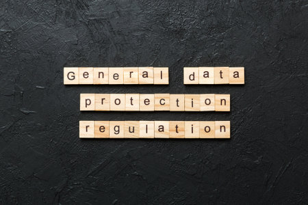 GDPR word written on wood block. General Data Protection Regulation text on cement table for your design, concept.の写真素材