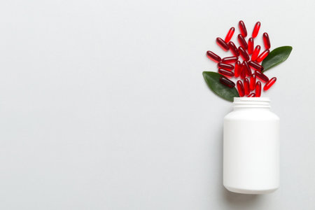 pills poured from a medicine bottle health care and medical top view on colored background.の写真素材