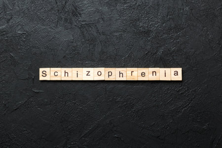 schizophrenia word written on wood block. schizophrenia text on table, concept.の写真素材