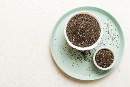 Chia seeds in bowl on colored background. Healthy Salvia hispanica in small bowl. Healthy superfood.の写真素材