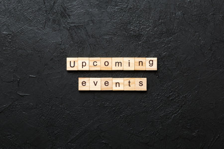 upcoming evente word written on wood block. upcoming event text on table, concept.の写真素材