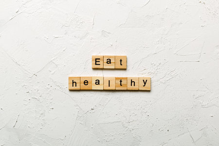 Eat Healthy word written on wood block. Eat Healthy text for your design, concept.の写真素材