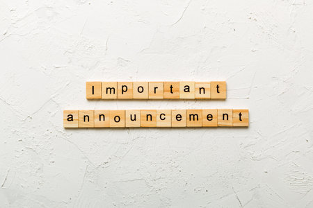 Important announcement word written on wood block. Important announcement text on cement table for your design, Top view concept.の写真素材