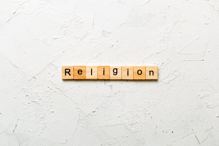 Religion word written on wood block. Religion text on cement table for your design, concept.の写真素材