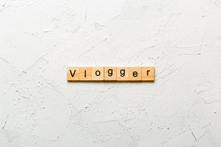 vlogger word written on wood block. vlogger text on table, concept.の写真素材