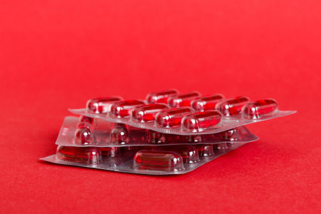 too many different pill cartridges stacked. selective focus. Packs of blister pills with tablets. Colored pastilles packages. A pile of medicine in blister packs. Pharmaceutical blister packs.の写真素材