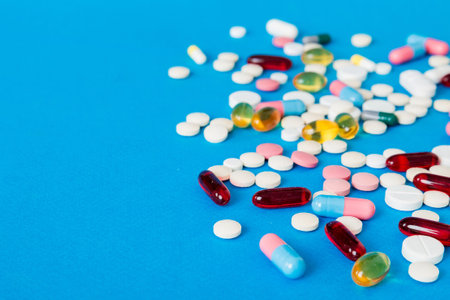 Many different colorful medications and pills perspective view. Set of many pills on colored...