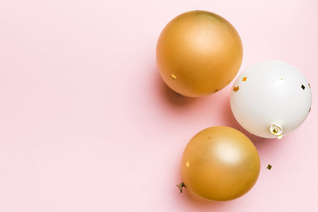 Background with festive air balloons of round shape and confetti, multicolored top view. birthday party background.の写真素材