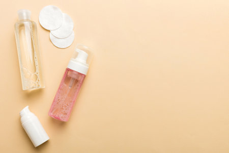 Micellar cleansing water and discs to remove cosmetics and cleanse the skin on colored background. Copy space top view.の写真素材