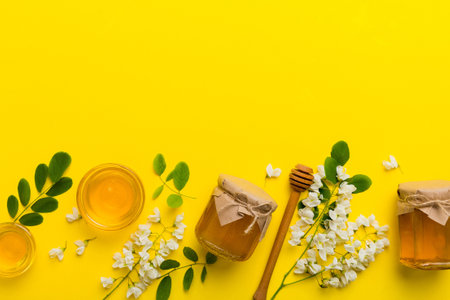 honey jar with acacia flowers and leaves. fresh honey top view flat lay.の写真素材