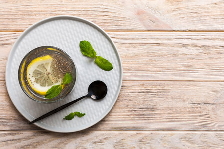 Healthy breakfast or morning with chia seeds lemon and mint on table background, vegetarian food, diet and health concept. Chia pudding with lemon and mint.の写真素材