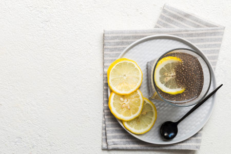 Healthy breakfast or morning with chia seeds and lemon on table background, vegetarian food, diet and health concept. Chia pudding with lemon.の写真素材