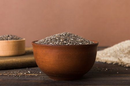 Chia seeds in bowl on colored background. Healthy Salvia hispanica in small bowl. Healthy superfood.の写真素材