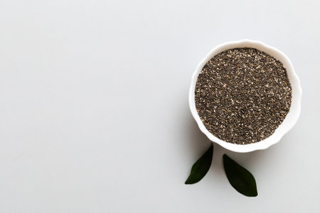 Chia seeds in bowl on colored background. Healthy Salvia hispanica in small bowl. Healthy superfood.の写真素材