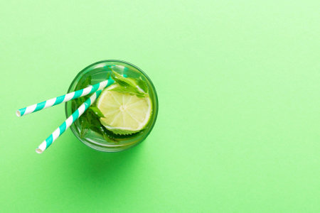 Caipirinha, Mojito cocktail, vodka or soda drink with lime, mint and straw on table background....